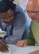 two men looking at diagram