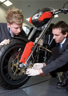 two young men working on a motorbike